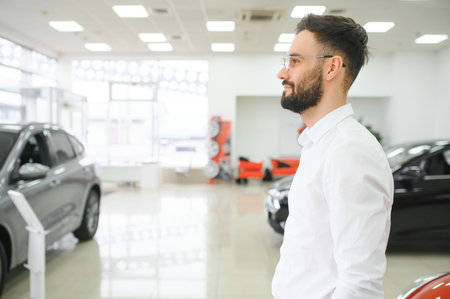 Man confident customer buyer male client wear white shirt choose auto want buy new automobile in showroom vehicle dealership store motor show indoor Sales conceptの写真素材