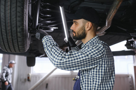 Auto mechanic working at auto repair shop.の写真素材