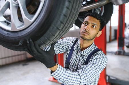 Indian happy auto mechanic in blue suitの写真素材