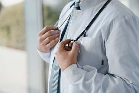 Portrait of senior doctor showing bottle of pills.の写真素材