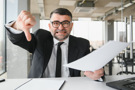 Angry businessman with document shouting at somebody.の写真素材