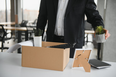 Portrait of sad dismissed senior old business man worker taking his office supplies in the box....
