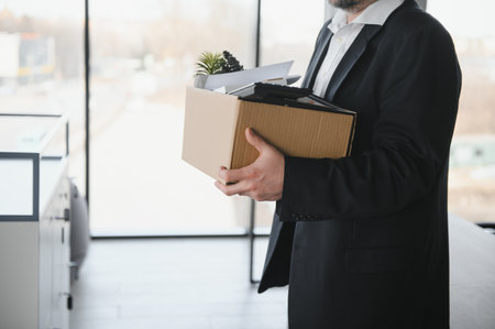 Stressed retired man leaving his office.の写真素材