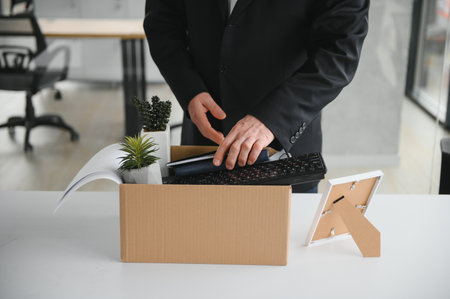 Old male employee being fired from his work.の写真素材