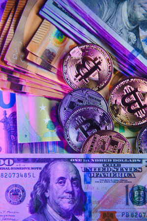 Bitcoin on background of US dollars, euro banknotes. Electronic decentralized money, exchange rate and growth of cryptocurrencies.の写真素材
