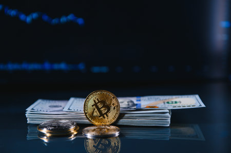 A symbolic coins of bitcoin on banknotes of dollars. Exchange bitcoin cash for a dollarの写真素材