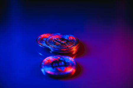 Bitcoin crypto currency illuminated by red and blue light. Blockchain technology concept used by crypto currencies like Bitcoin and Ethereum.の写真素材