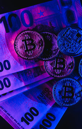 Golden bitcoin over euro money. bitcoin cryptocurrency. Cryptocurrency concept. Bitcoin with euro...