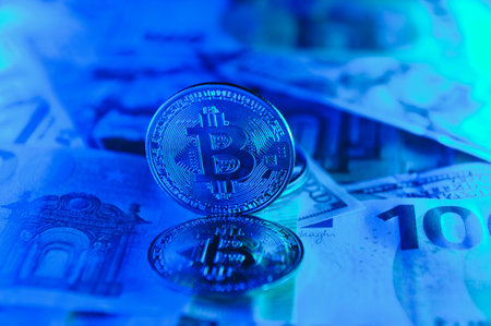 golden bitcoins new virtual currency with traditional dollars and euro as a background.