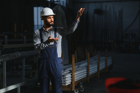 portrait of industrial engineer. Factory worker with hard hat standing in factoryの写真素材