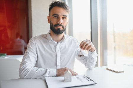 Portrait of a young realtor in the office at the table. real estate sales concept