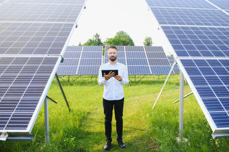 solar power plant. Engineer on a background of photovoltaic panels. science solar energy.の写真素材