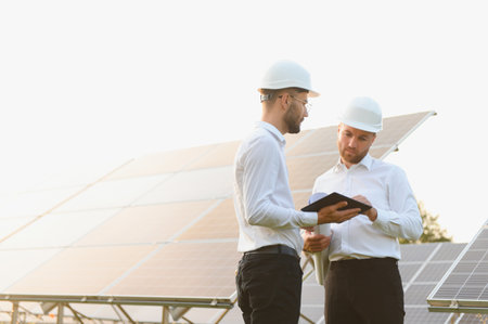 Project manager discuss with worker installation process of solar panel.の写真素材