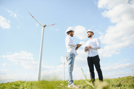 Young maintenance engineer team working in wind turbine farmの写真素材