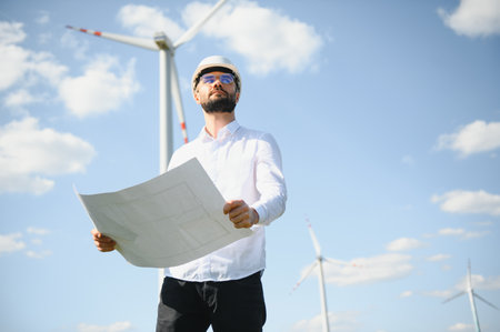 Engineer working at alternative renewable wind energy farm - Sustainable energy industry concept.の写真素材
