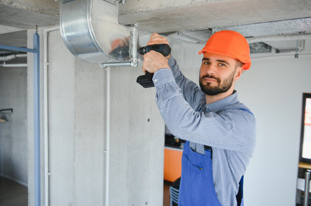 hvac worker install ducted pipe system for ventilation and air conditioning. copyspace.の写真素材