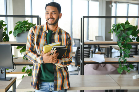 Happy indian male student at the university.