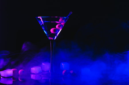 Drink Martini. Martini with olives on a black table. Free space for textの写真素材