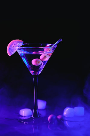 Glass of classic dry martini cocktail with olives on dark table against black background. With free space for your text.の写真素材