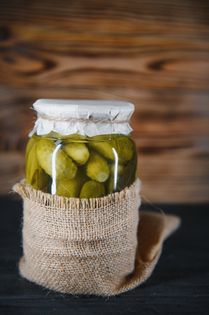 Pickled cucumbers in the jar. Ingredients for pickling cucumbers. Cucumbers, dill, garlic. Glass jars with pickles.の写真素材