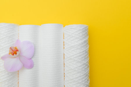 water filters. Carbon cartridges and a glass on a yellow background. Household filtration system.の写真素材