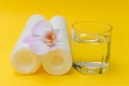 cartridges for water purification on a yellow background. Concept of clean water at home.の写真素材