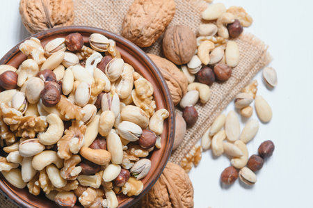 Mixed nuts on a plate. white background.