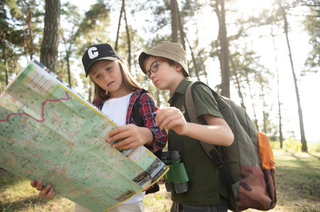 Girl scout frying marshmallows on fire at the woodsの写真素材