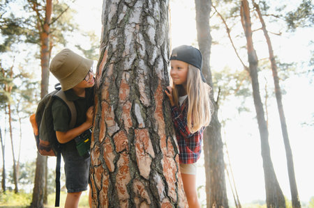 kids in green forest playing,concept of kids vacations and travel.の写真素材