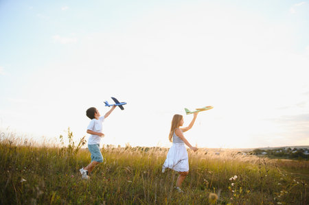 Active running kids with boy holding airplane toyの写真素材