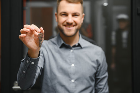 Friendly seller in window shop with keys. A large selection of windows and doors for the house. Home renovation concept.の写真素材