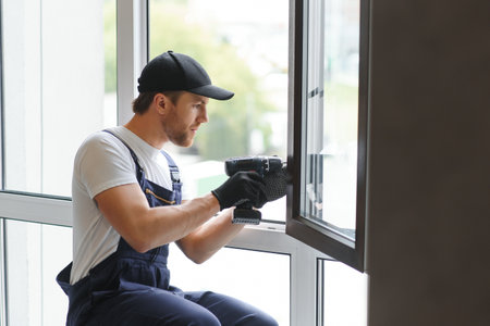 Construction worker installing window in house.の写真素材