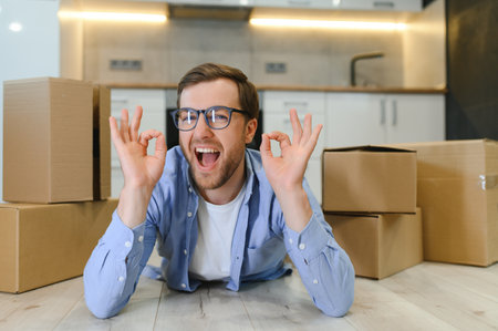 Smiling guy moving into his new home.の写真素材