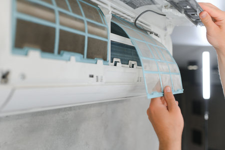 specialist cleans and repairs the wall air conditioner.