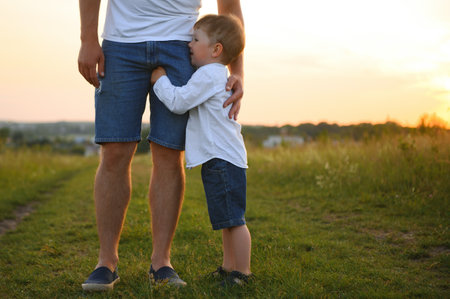father's day. Happy family father and toddler son playing and laughing on nature at sunset.の写真素材