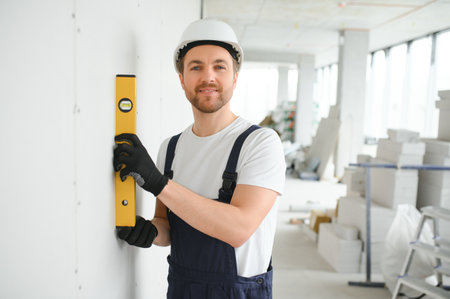 Professional Workman Applying Silicone Sealant With Caulking Gun on the Wall.の写真素材
