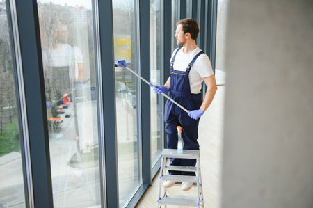 Male worker washing window glass.の写真素材