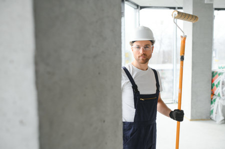 Worker renewing apartment on wall background