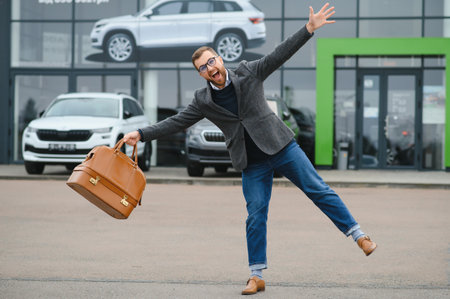 Young man in the car dealershipの写真素材