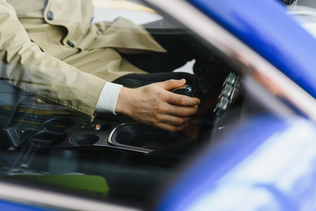 Male hand on the shift lever of the transmission in the carの写真素材