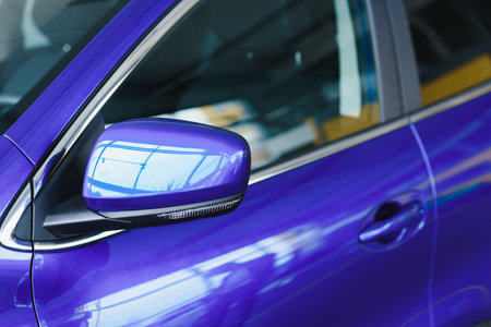 Rear-view mirror closed for safety at car park, Rear-view mirror of gray car , black tinted glass. Close up of wing mirror of gray vehicle. selective focus.の写真素材