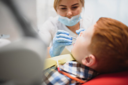 Female dentist and child in a dentist officeの写真素材