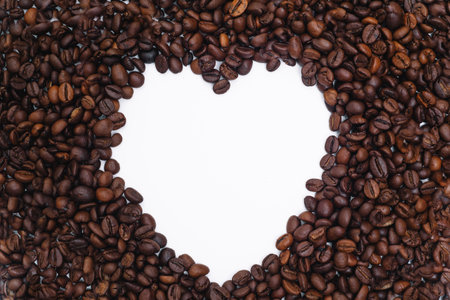 Coffee beans in heart shape white background isolated.