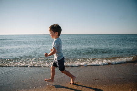 cute little boy running on the beach and have fun.の写真素材