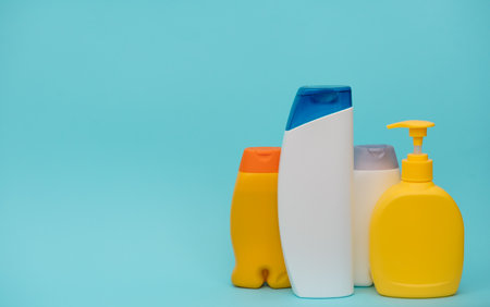 Shower accessories on a colored background. bathroom setting on blue background. means of body hygiene.の写真素材