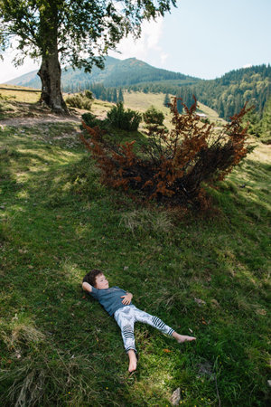 Little boy walking near a mountain village.の写真素材