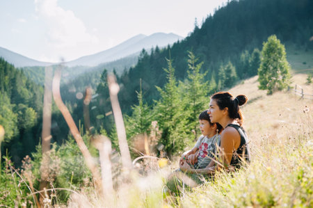 Young mom with baby boy travelling. Mother on hiking adventure with child, family trip in mountains. national park. Hike with children. Active summer holidays. fisheye lensの写真素材