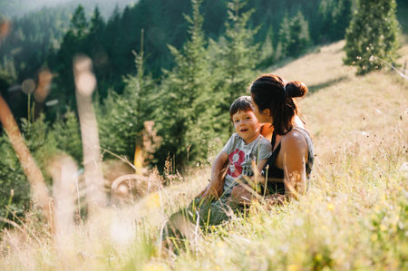 Young mom with baby boy travelling. Mother on hiking adventure with child, family trip in mountains. national park. Hike with children. Active summer holidays. fisheye lensの写真素材