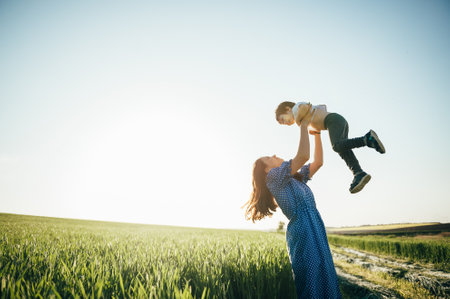 Stilish mother and handsome son having fun on the nature. happy family concept. Beauty nature scene with family outdoor lifestyle. Happy family resting together. Happiness in family life. mother's day.の写真素材