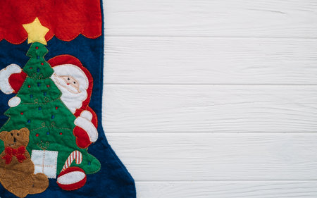Christmas fir tree with decoration and glitters on wooden background. Christmas background on the white wooden deskの写真素材